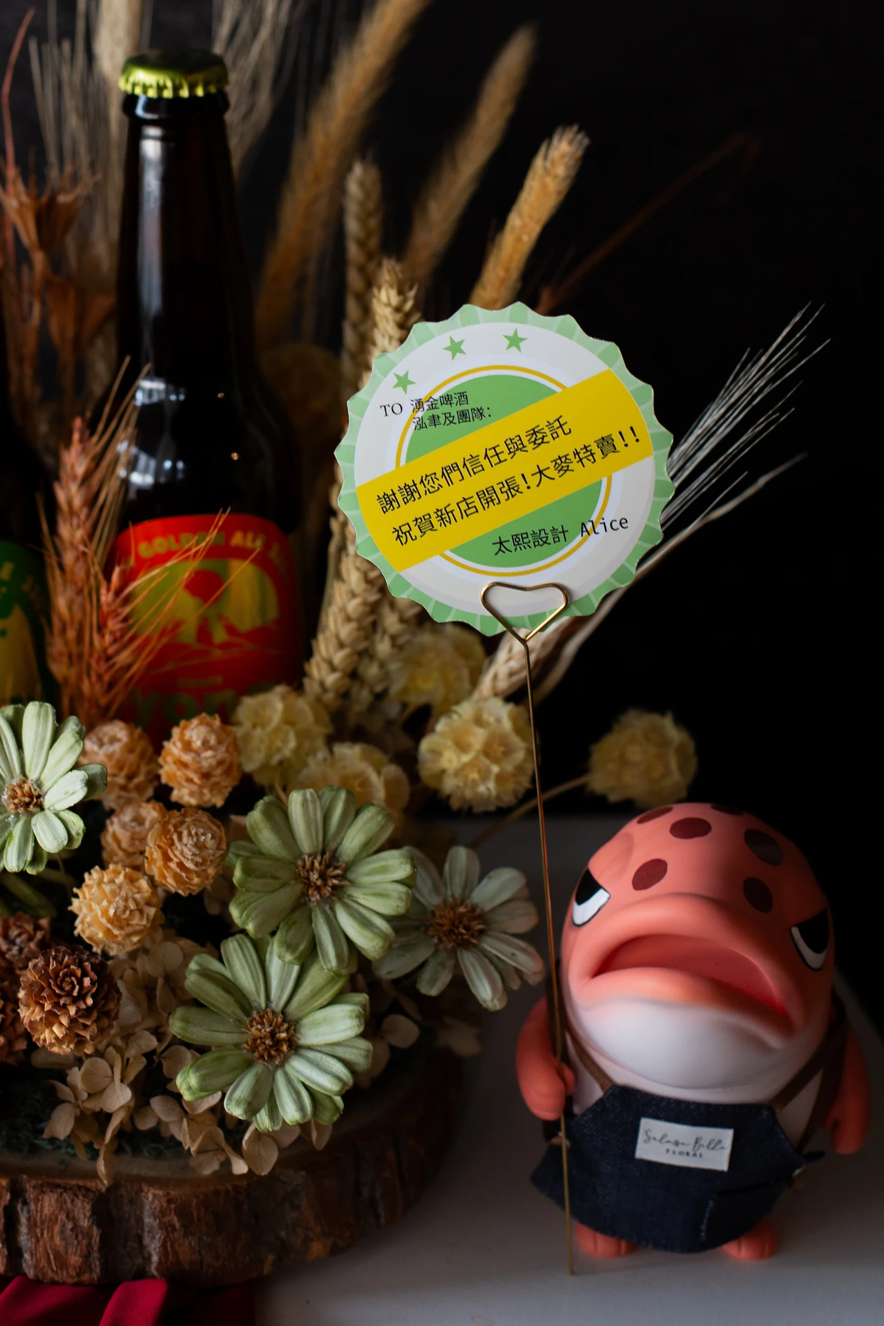 鮭毛先生公仔手持祝賀卡——卡片寫著大麥特賣的雙關祝福